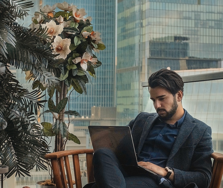 affluent man on laptop meant to showcase an potential investor looking for collateral as part of their due diligence